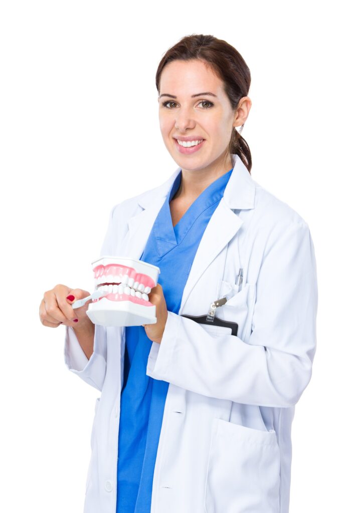 Dentist with toothbrush on denture